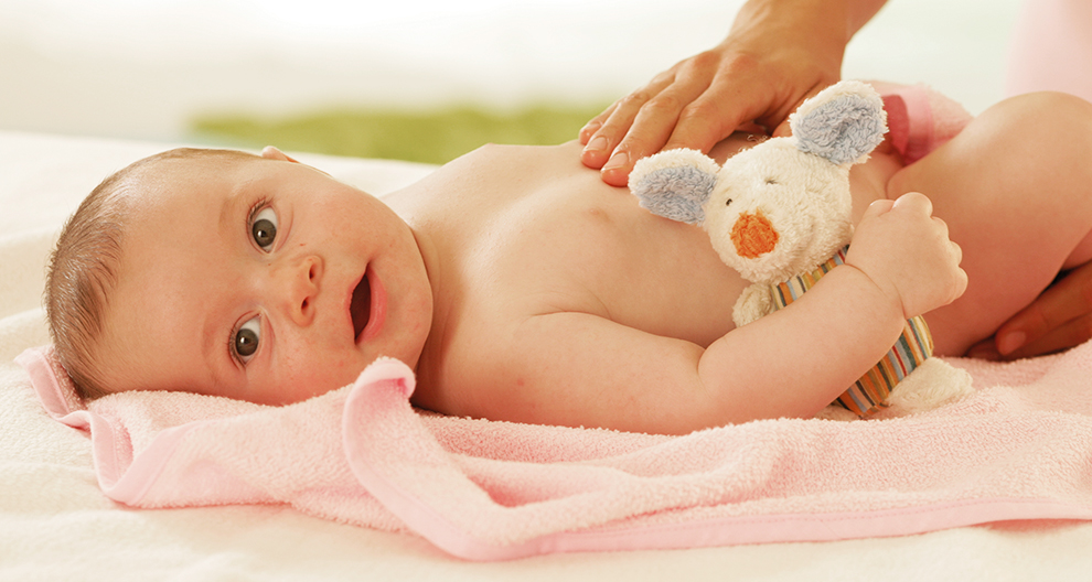 Baby, towel, teddy bear, hands.