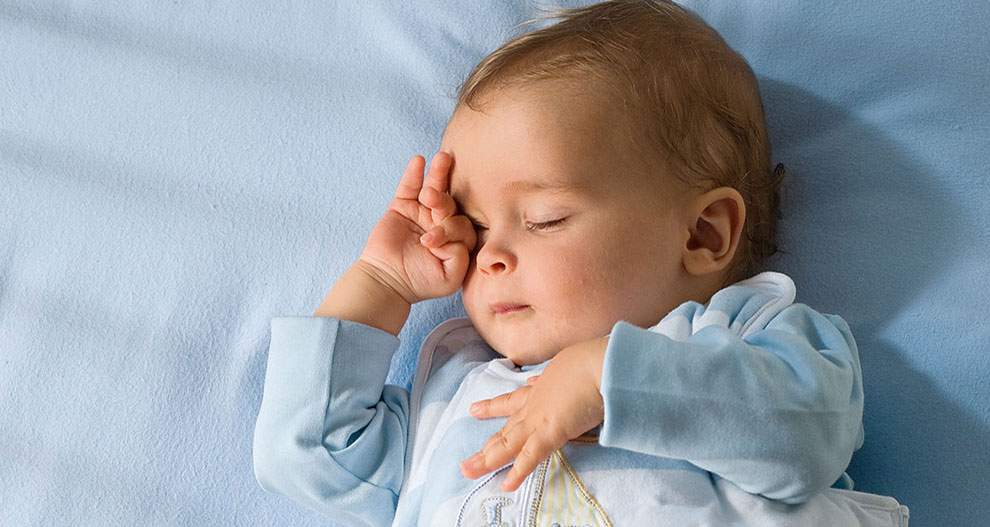 Baby, sleeping, hand on face.